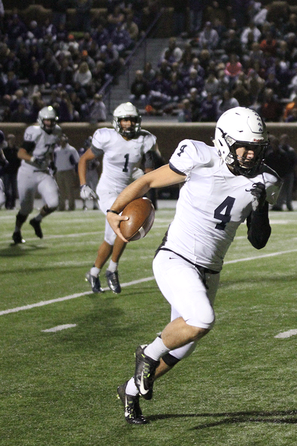 Senior quarter back Logan Koch runs the ball down the field.