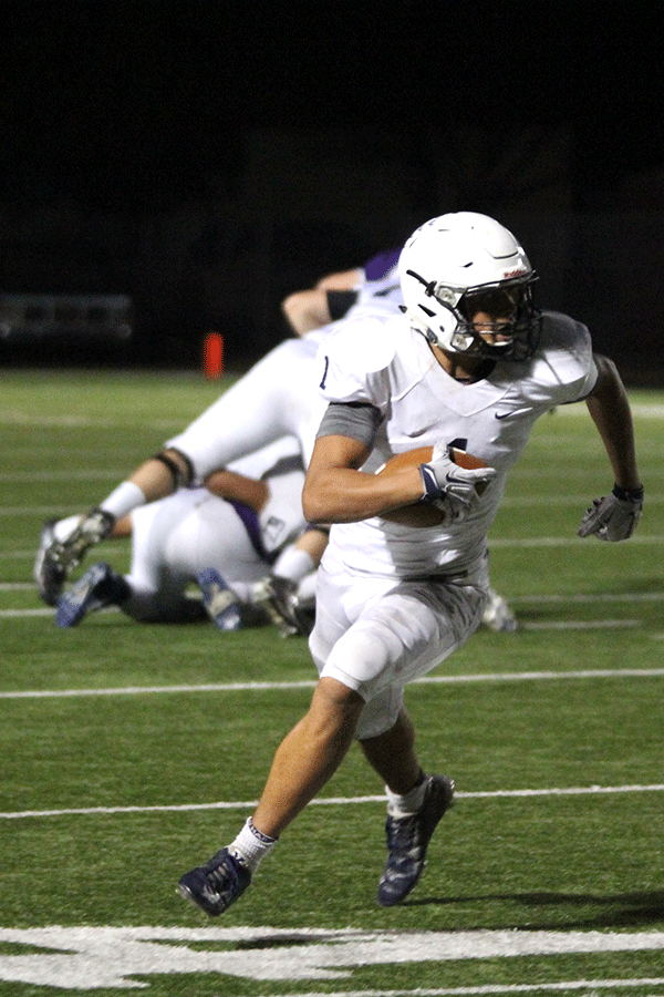 Racing down the field, senior wide receiver Christian Jegen avoids Pittsburg's defensive linemen.