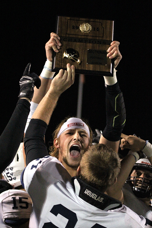 Senior Lucas Krull holds up the sectional trophy in celebration.