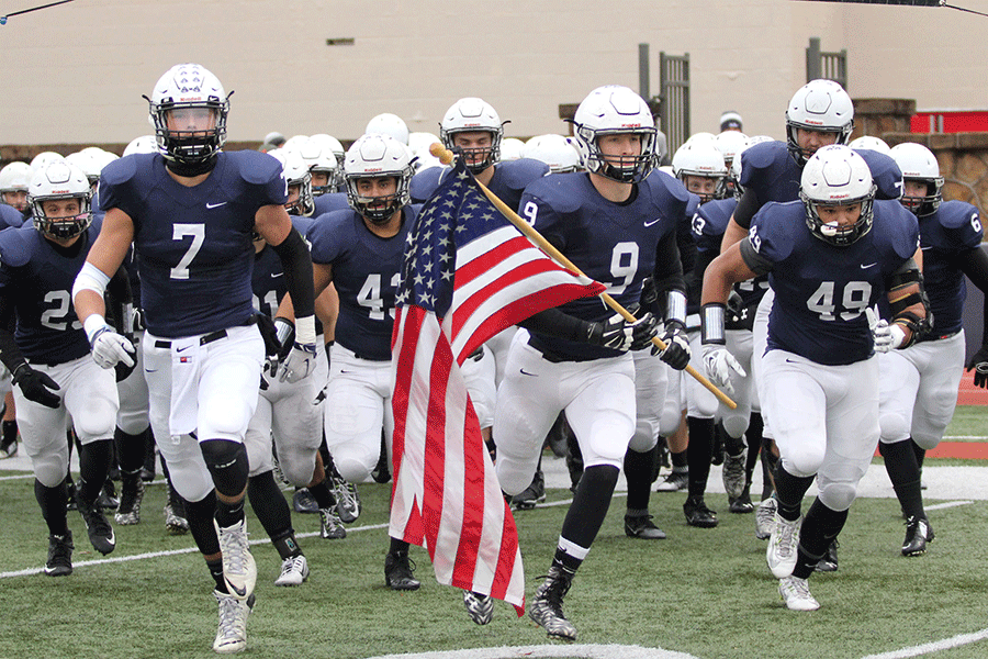 Senior players lead the team onto the field at the start of the 5A State Championship game.