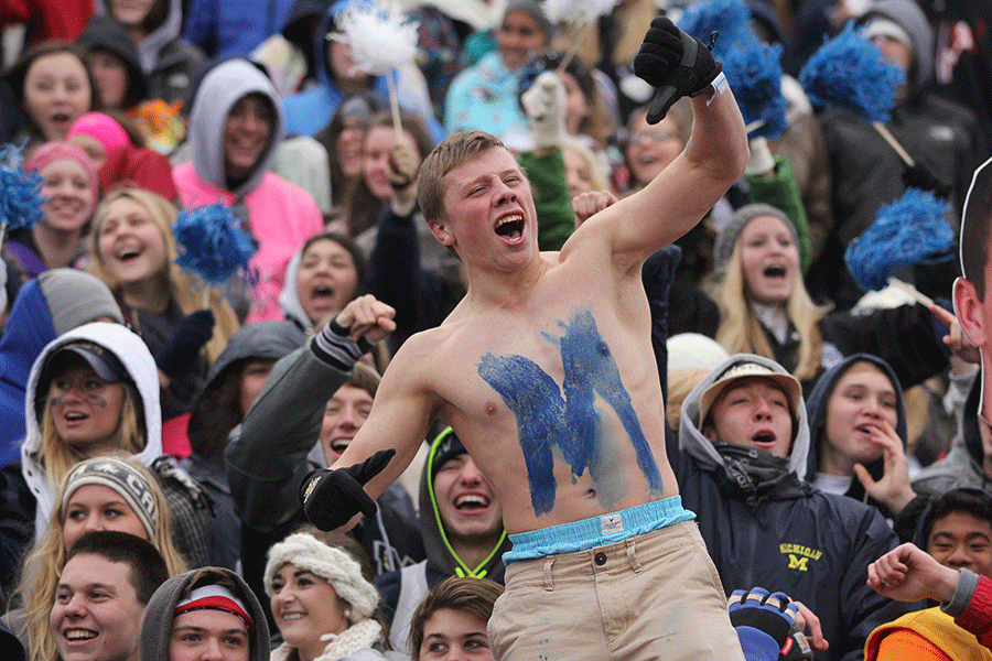 Senior Ryan Anderson cheers on the team along with the student section.