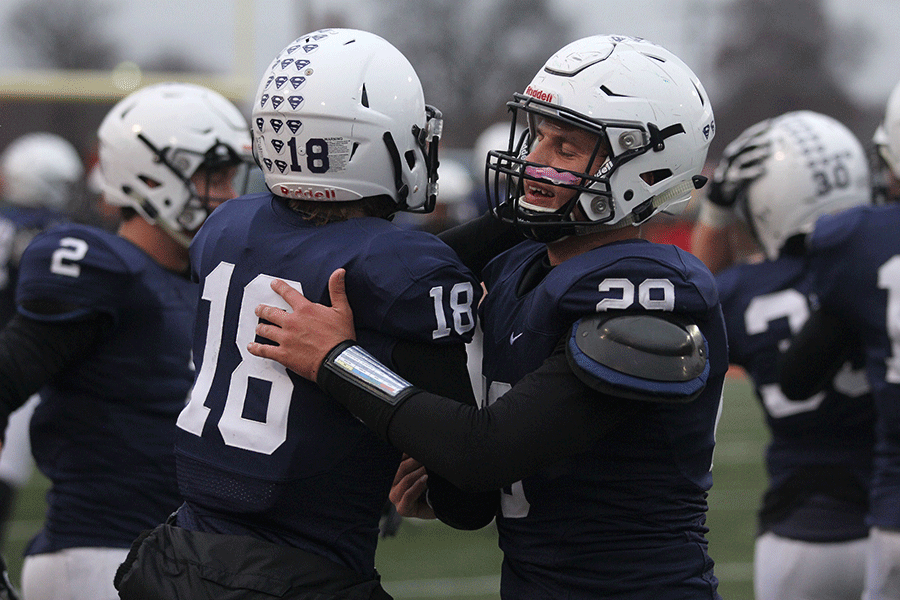 Senior Seth Burnett and sophomore Evan Rice celebrate the team's state win.