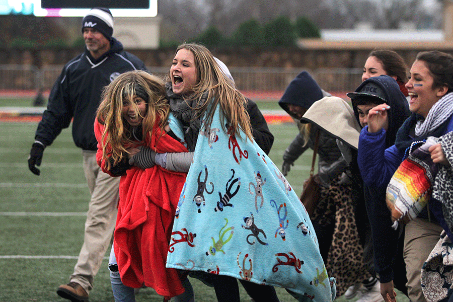 Sophomores Emma Maddox and Lucy Holland storm the field together. 