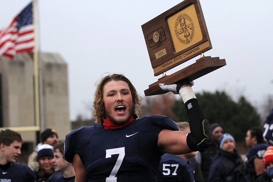 Senior Lucas Krull holds the state championship trophy after the game.