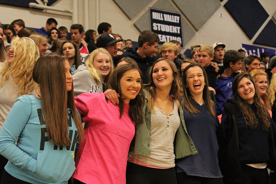 Fans lock arms during the alma mater.