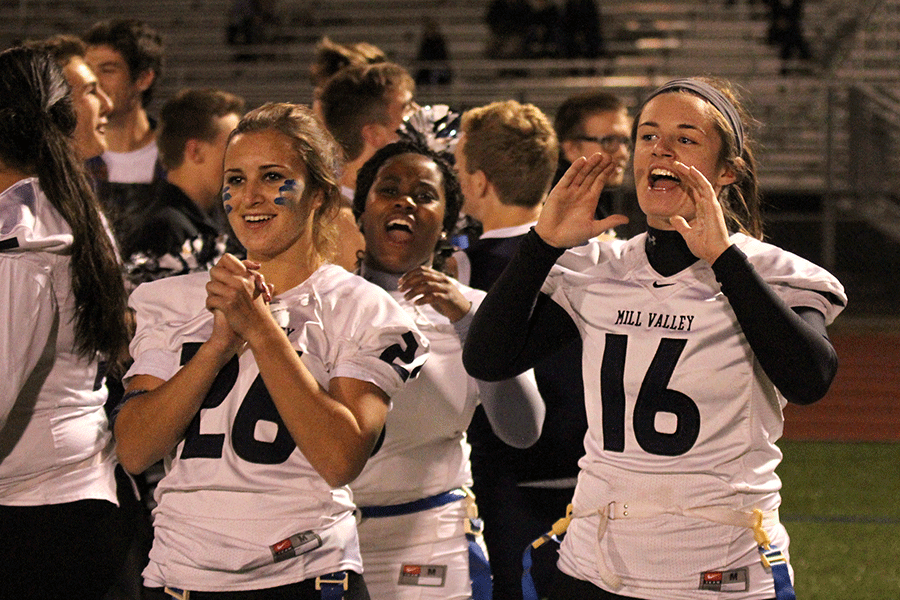Seniors Sydney Hanson and Olivia Barber cheer for their teammates from the sidelines during the Powder Puff game.