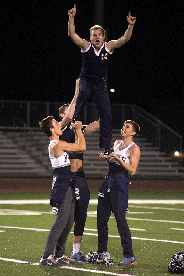 During halftime of the Powder Puff game, senior Dalton Sieperda performs a stunt with other senior boys.