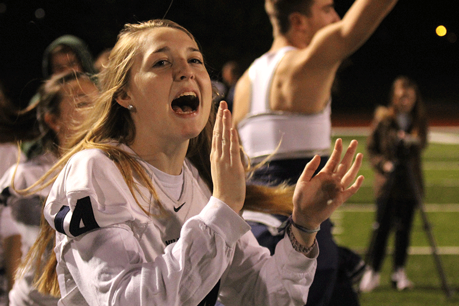 Senior Avery Kilgore cheers on her teammates after seniors score a touchdown.