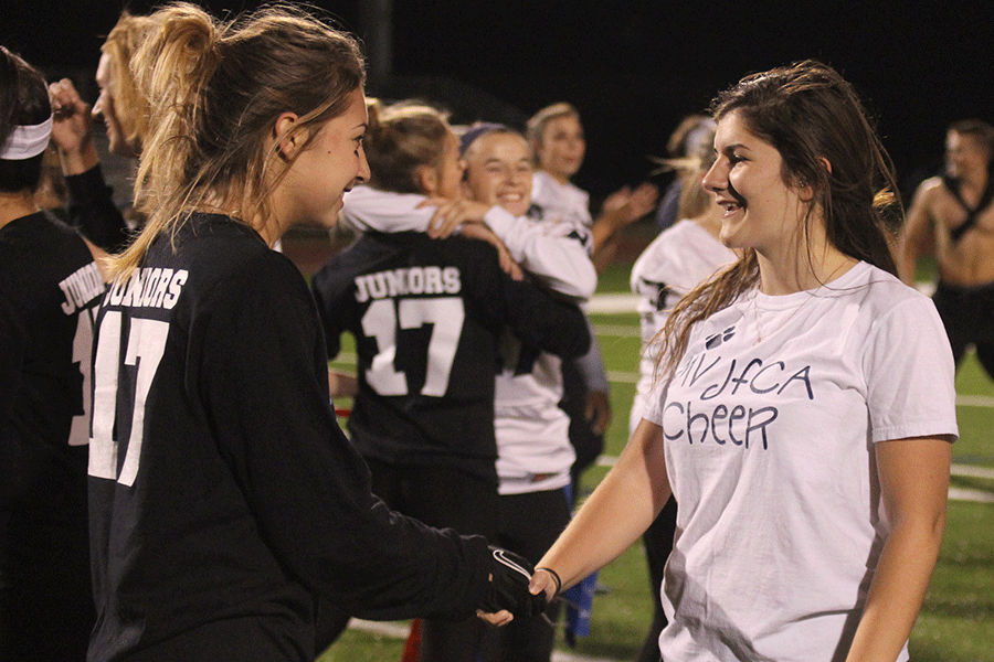 Post-game, senior Val Merriman congratulates junior Emma Mantel for playing a good game.