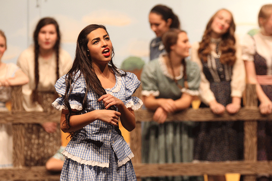 Singing Many A New Day, senior Gabby Saunders plays with her hair. Oklahoma! is set to premiere Saturday, Nov. 7.