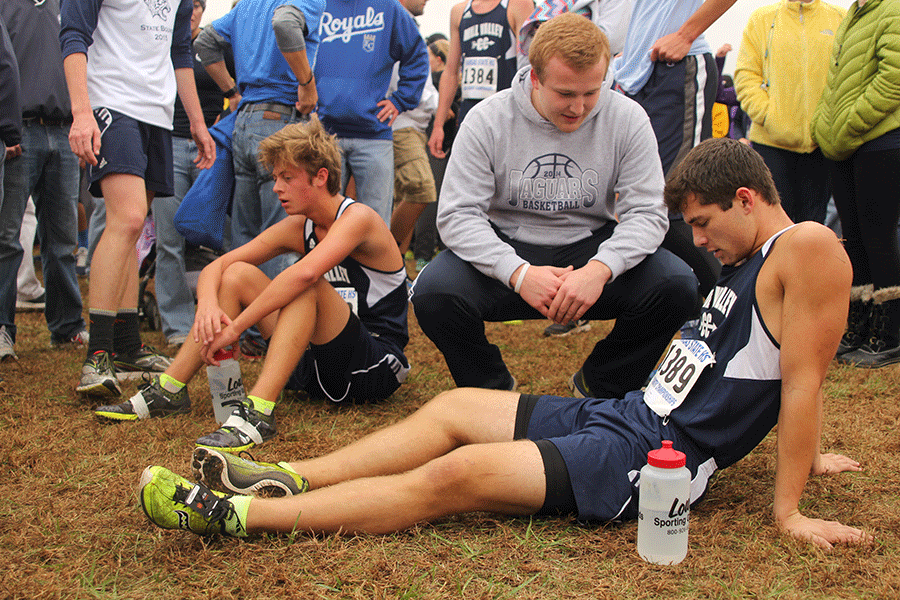 Senior Derek Meeks is met by 2015 graduate Mitch Perkins after the race. 