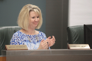 As she listens to a presentation about state assessment scores, Board of Education member Danielle Heikes applauds district students on Monday, Nov. 2. The Board appointed Heikes in October to fill position four after Scott Hancock, the position's previous holder, was recalled in August.