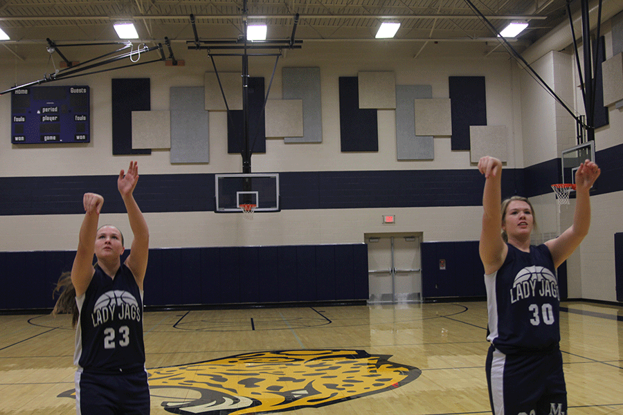 Sisters and teammates senior Catie Kaifes and freshman Claire Kafies take practice shots to warm up for basketball practice on Friday, Nov. 20. I saw how much fun Cooper and Conner had playing together last year, and I hope my experience will be just like that,Claire said.