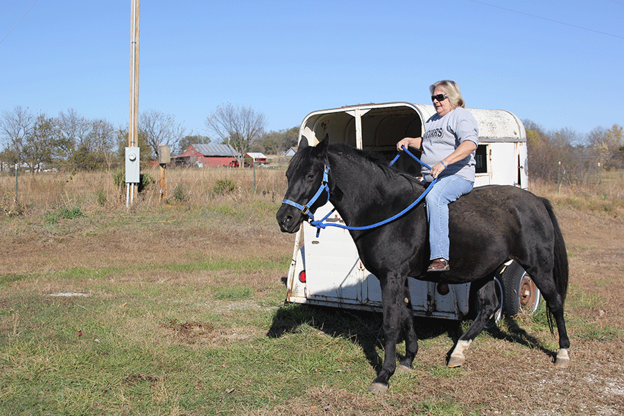 Off a dirt road in McClouth custodian Rhonda Jensen rides her horse on Sunday, Nov. 8. “I just love to ride,” Jensen said. “I like to go trail riding, but I haven’t had the time.”