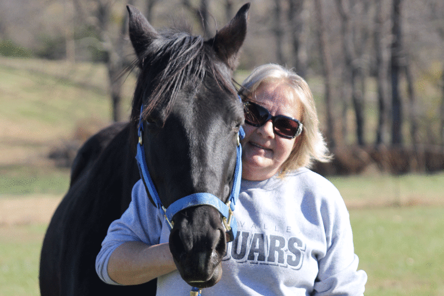  At custodian Rhonda Jensen’s house on Sunday, Nov. 8, Jensen stands next to her horse named Star. “I love animals. I’d rather be around animals than I would people. They talk back, even though you can’t understand them. They’re beautiful,” Jensen said.