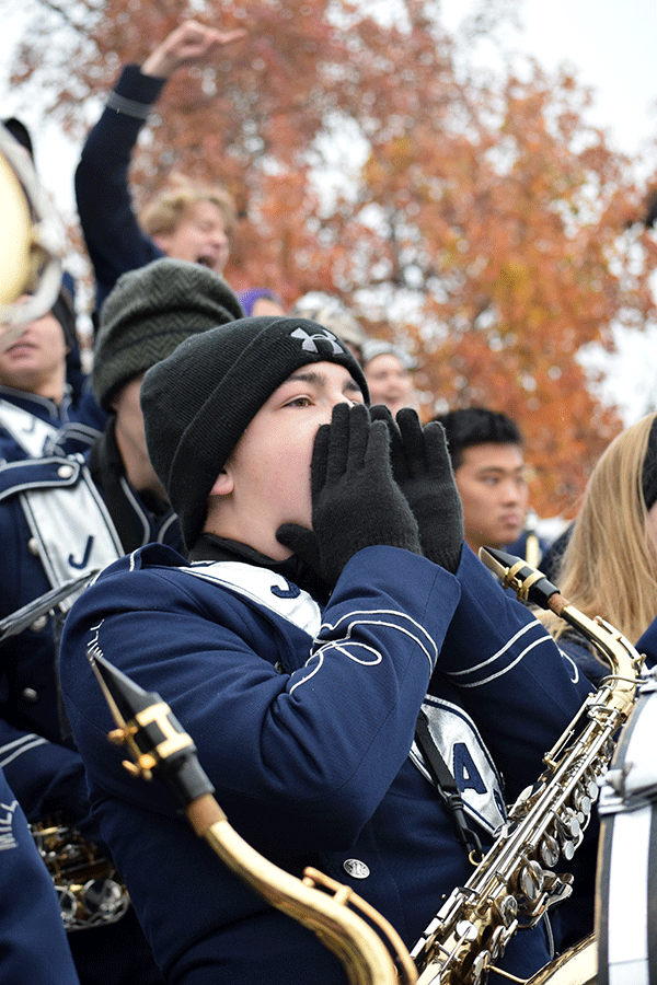 From the band section, junior Collin Petigna cheers. 