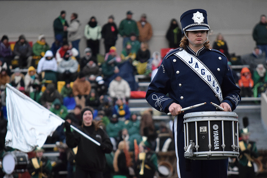 Senior Mitch Cowan stands in formation during the band’s halftime show. 
