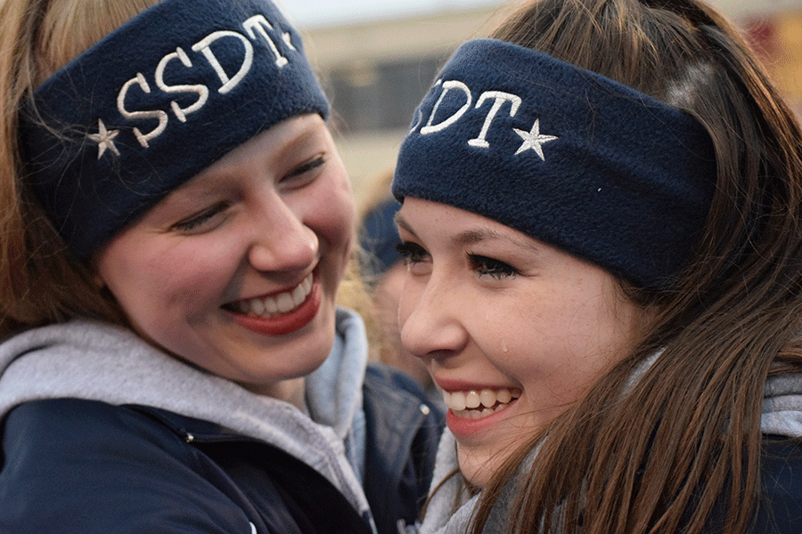 Senior Abbie Hughes is hugged by senior Natalie Golden after the game. 
