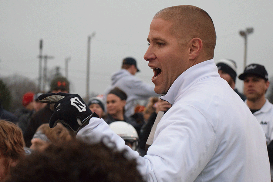 Head coach Joel Applebee talks to the team and the student section on the field after the game. 