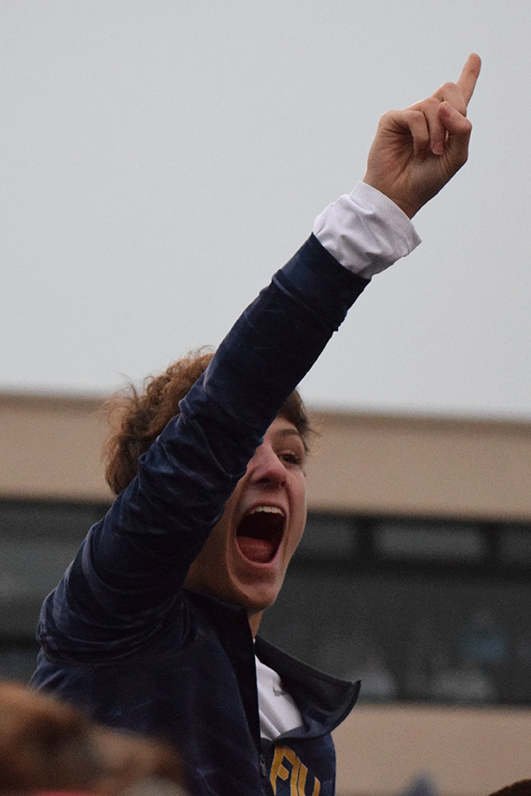  After the game, junior Adam Grube is lifted onto the shoulders to over the crowd of fans that stormed the field. 