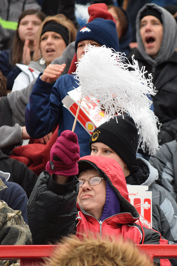 A Mill Valley fan cheers with a pom pom.