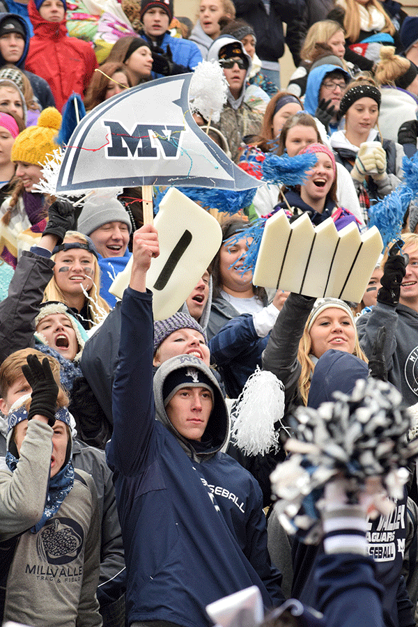 Senior Clay McGraw holds his MV shark fin in the air to celebrate a Jaguar first down. 
