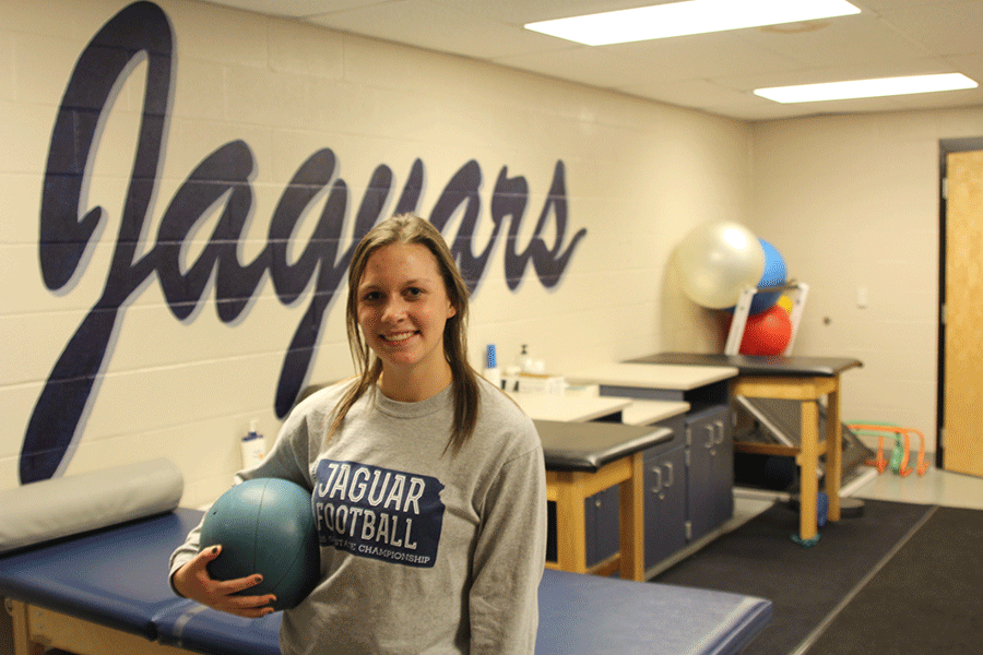 Standing in the Mill Valley training room on Thursday, Dec. 3, sophomore Miranda Toland holds a medicine ball. [As a student trainer] I get a lot of experience for when I go off to college so its not like Im starting completely blind, Toland says.