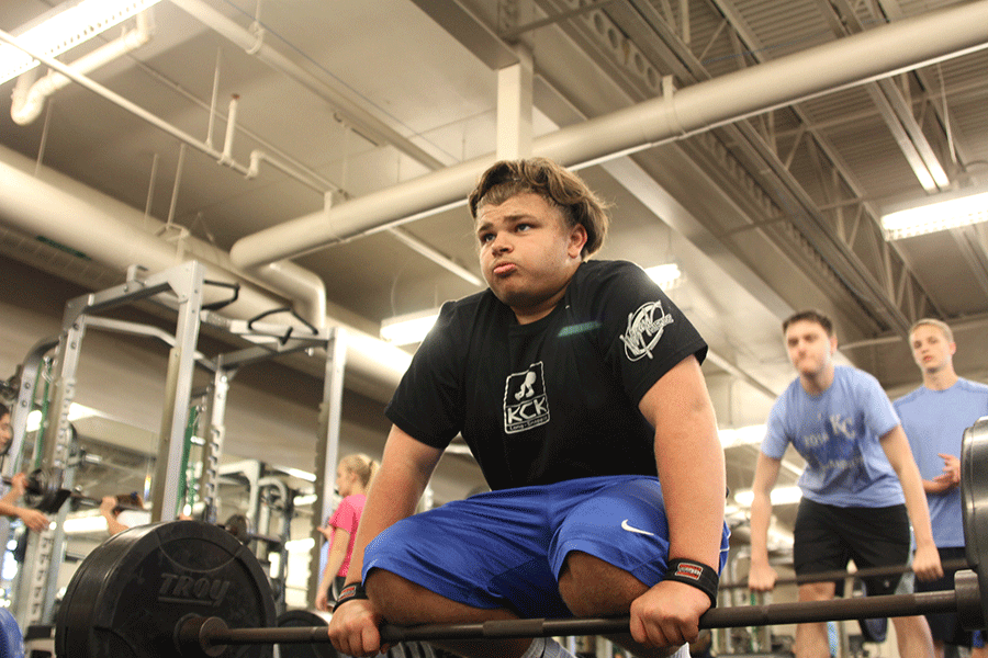 In the weight room on Tuesday, Nov. 24, senior Koy Holden gets ready in his stance to hang clean. “[I took strength and conditioning] to get faster and stronger and to work out before golf season,” Holden said. 