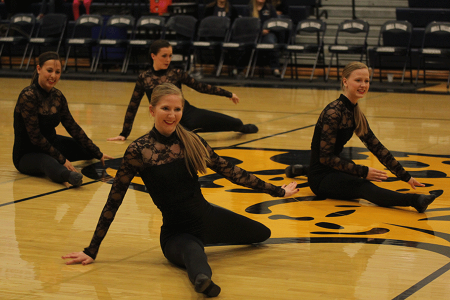 Senior Sydney Ward dances with the Silver Stars during half time.