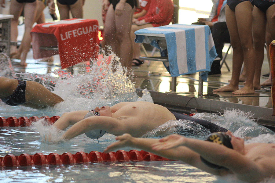 Starting the race, senior Will Dervin pushes himself off the wall.