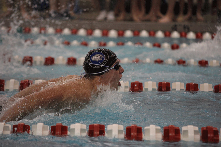 Coming close to the finish, junior Garrison Fangman competes in the 100 yard butterfly.