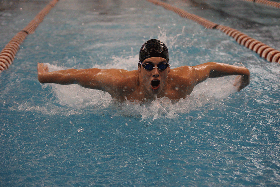 In the 100 yard butterfly, junior Garrison Fangman places third on Tuesday, Dec. 8. 