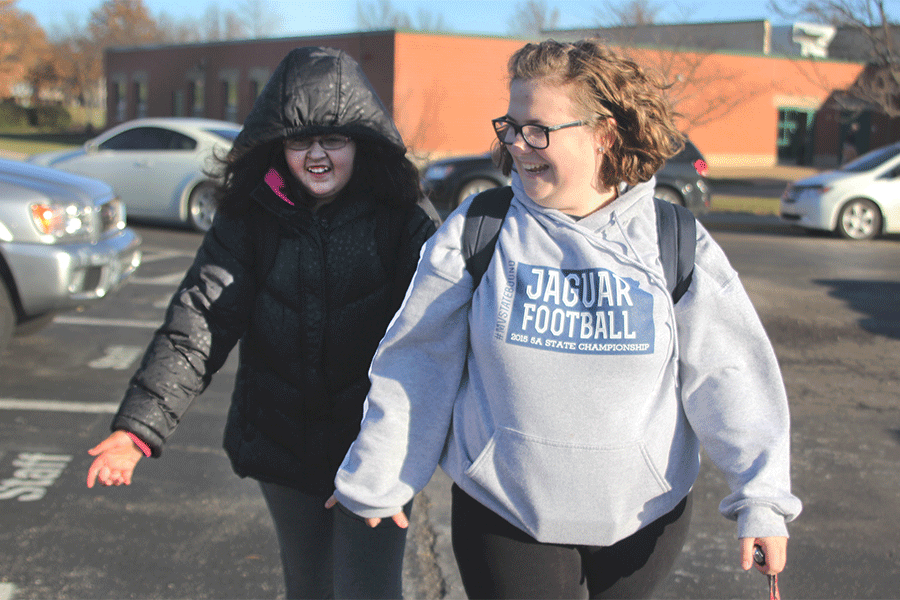 After school, senior Rachel Morgan picks up eighth grader Alyssa Fagan from Monticello Trails Middle School. “Watching [the kids] progress, in the end, really makes a difference,” Morgan said.