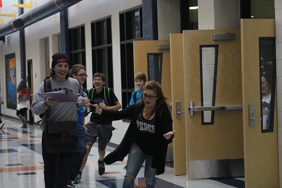 During the lunch intruder drill on Tuesday, Dec. 1, sophomores Parker Johnson and Kaylee Berrios run to the nearest exit to evacuate the commons. 