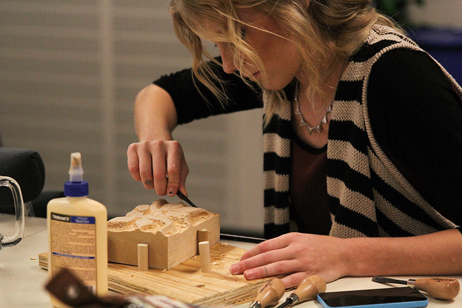 Senior Nicole Stoneburner works on her wood-carving project - a new addition to the Advanced Sculpture class.