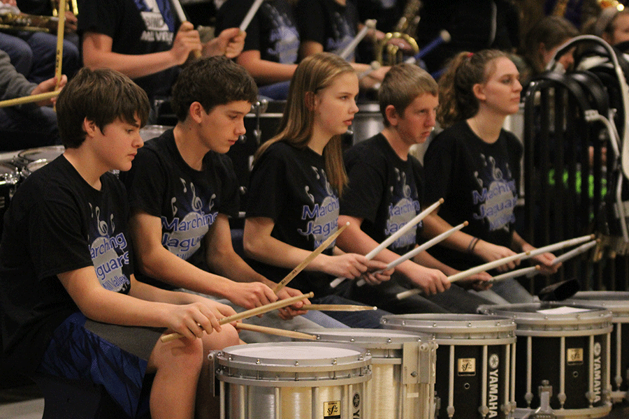Members of the drumline play during halftime.