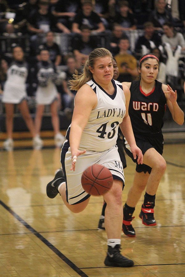 Junior Ashlyn Hendrix runs down the court to make a basket.