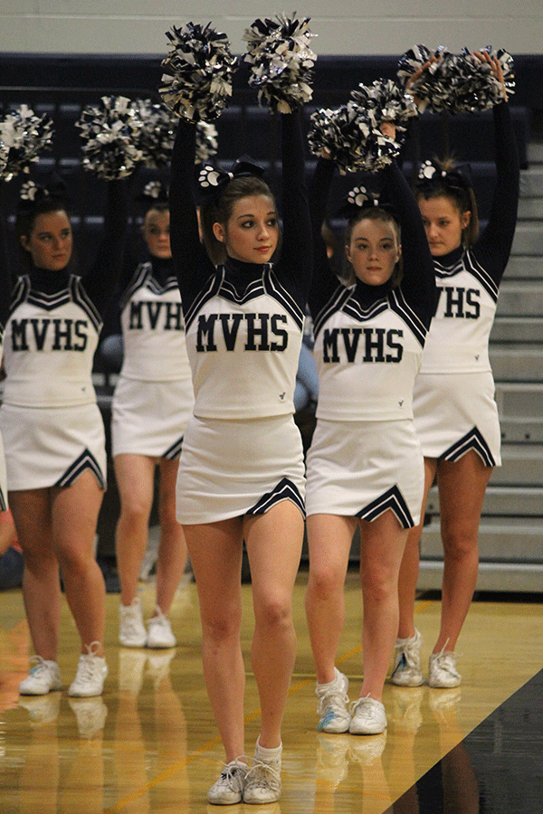 Junior Maci Foerderer raises her hands when a Lady Jag shoots a free throw.