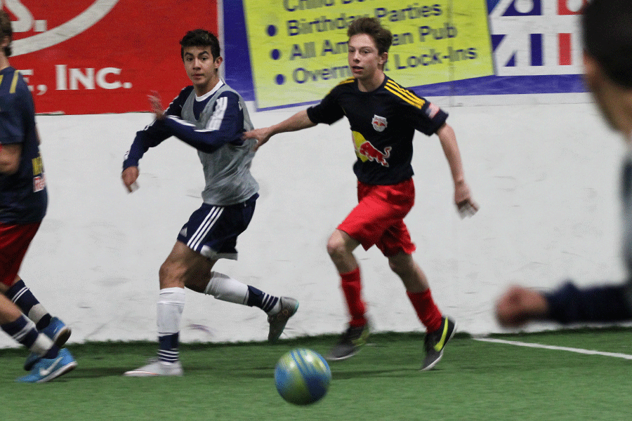 Racing ahead of the other team, freshman Jack Matchette pushes off a defender to get the ball on Sunday, Nov. 28. 