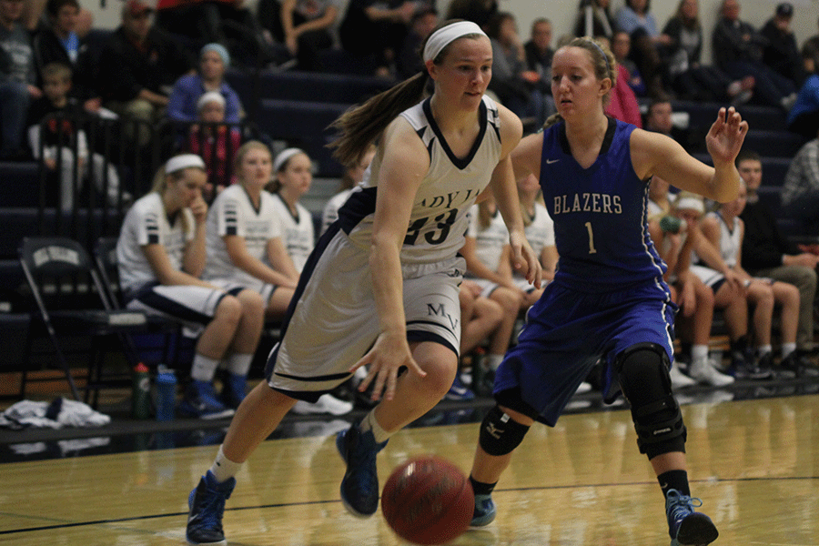 As she dribbles down the court, freshman Claire Kaifes pushes past a Gardner Edgerton opponent to make it to the basket on Tuesday, Dec. 8. The Lady Jags fell 42-51.