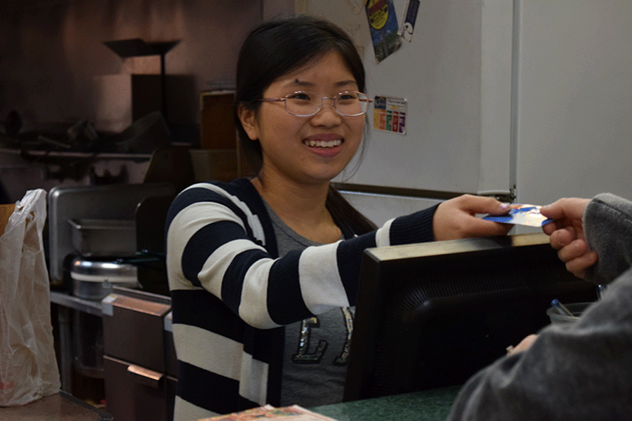 On Tuesday, Dec. 1, sophomore Wendy Chen works the cash register at her familys restaurant, China King. My family members are much more lenient and if I were to work for other people they would be much more strict ... It’s a lot better working for your family.