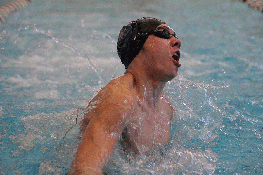 Competing in the 200 yard medley relay at Blue Valley Southwest on Tuesday, Jan. 26, senior Jeremiah Kemper comes up for air as he turns. 