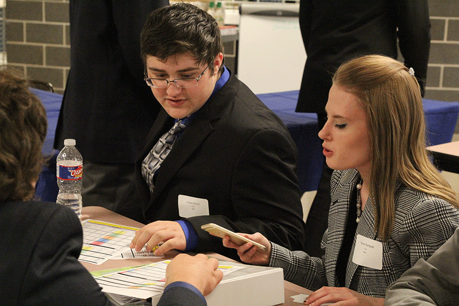 Waiting for their turns, seniors Tatum Rainbolt and Jordan Purvis study for their upcoming tests on Tuesday, Jan. 12 at the Leavenworth High School DECA competion.