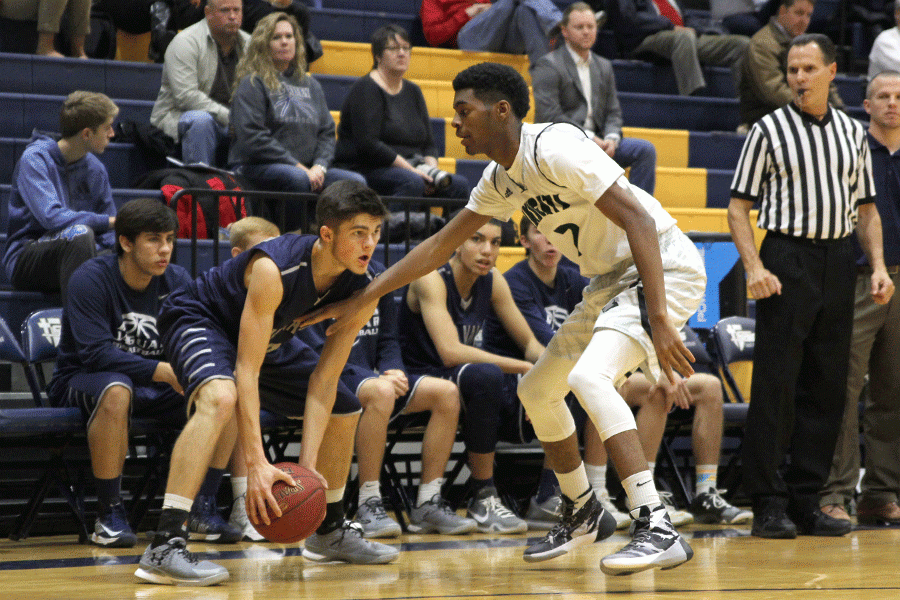 Waiting for a fellow teammate to pass to, senior Kasey Conklin holds the ball from a Barstow Knight. In the first round of the Saints Classic tournament, the Jaguars defeated the Barstow Knights 84-83 on Thursday, Jan. 21.