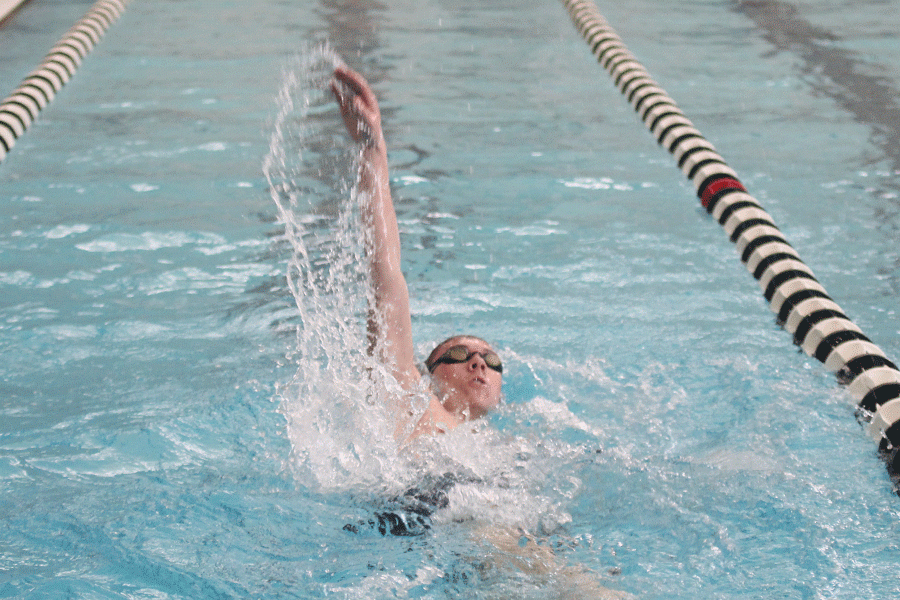 Senior Jeremiah Kemper does the backstroke in the 200 IM. 