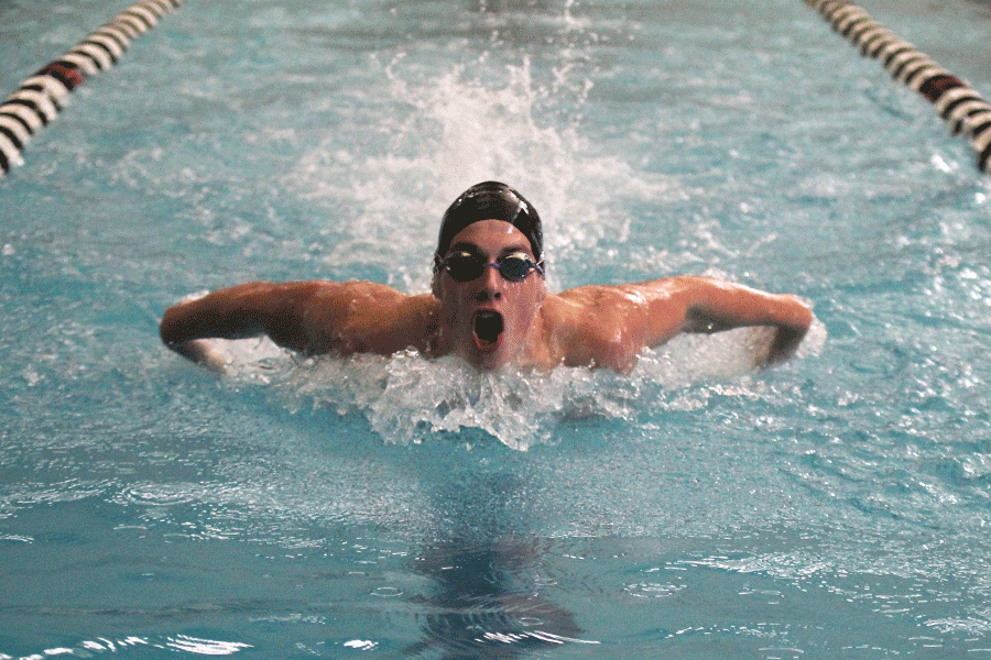 Junior Garrison Fangman emerges out of the water during the 100 yard butterfly. 