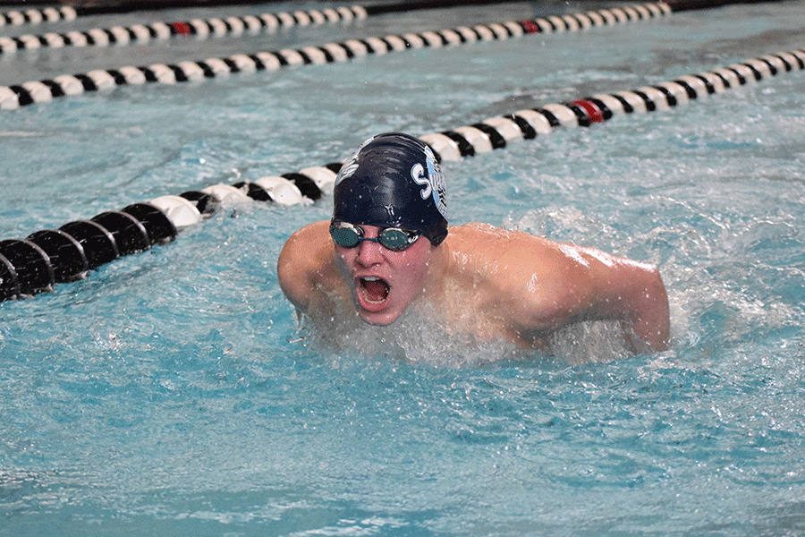 Near the end of the 100 yard butterfly, senior Adam Gray comes up for a breath. 