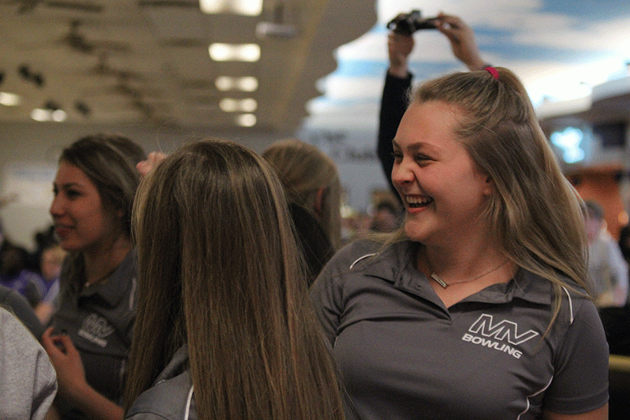 Senior Michaela Crispin laughs with a teammate after their breakdown. 