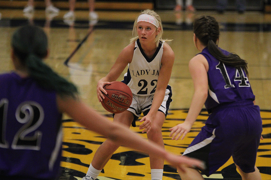 With the ball in hand, junior Courtney Carlson advances down the court. The Lady Jags fell 50-45 to the Pirates.