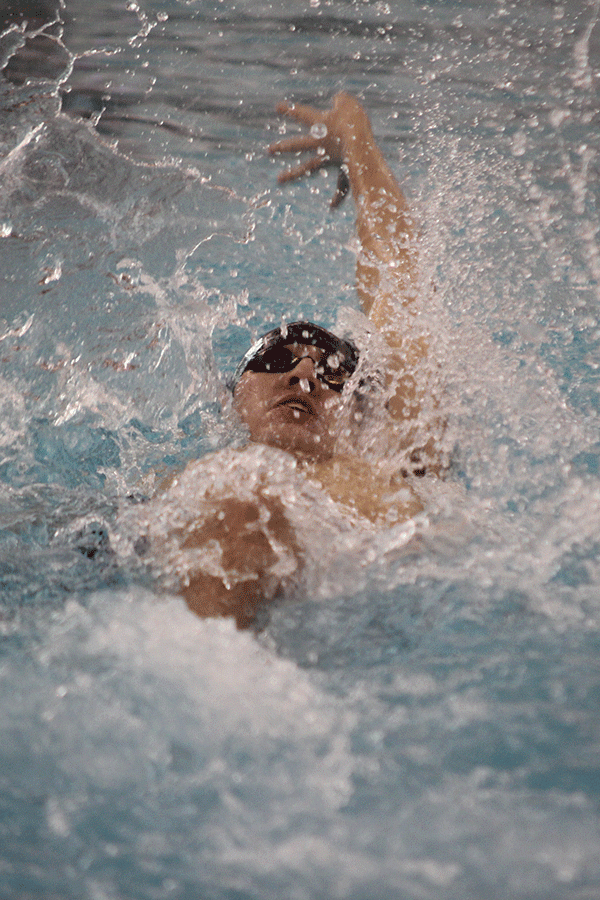 Senior Brennan Teasley participates in the 100 yard backstroke.